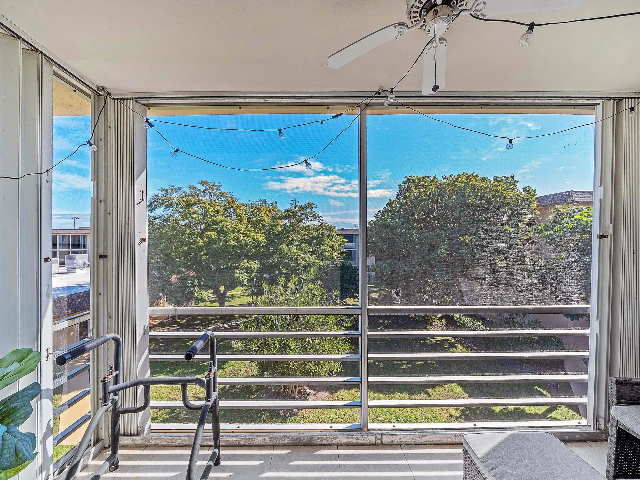 4500 North Federal Highway, Unit 303 Lighthouse Point, FL 33064 - Photo 19 of 40 a view of a balcony with floor to ceiling windows with wooden floor