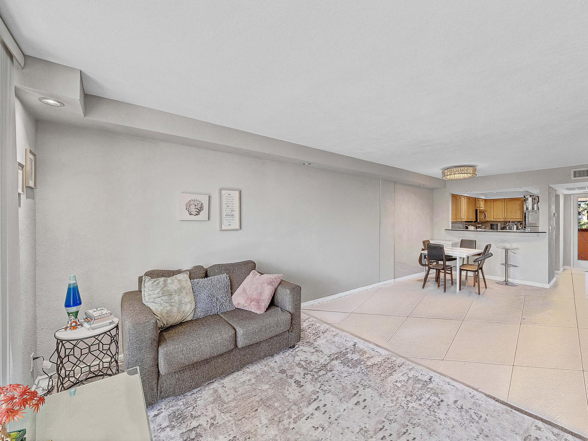 4500 North Federal Highway, Unit 303 Lighthouse Point, FL 33064 - Photo 22 of 40 a living room with furniture and a table