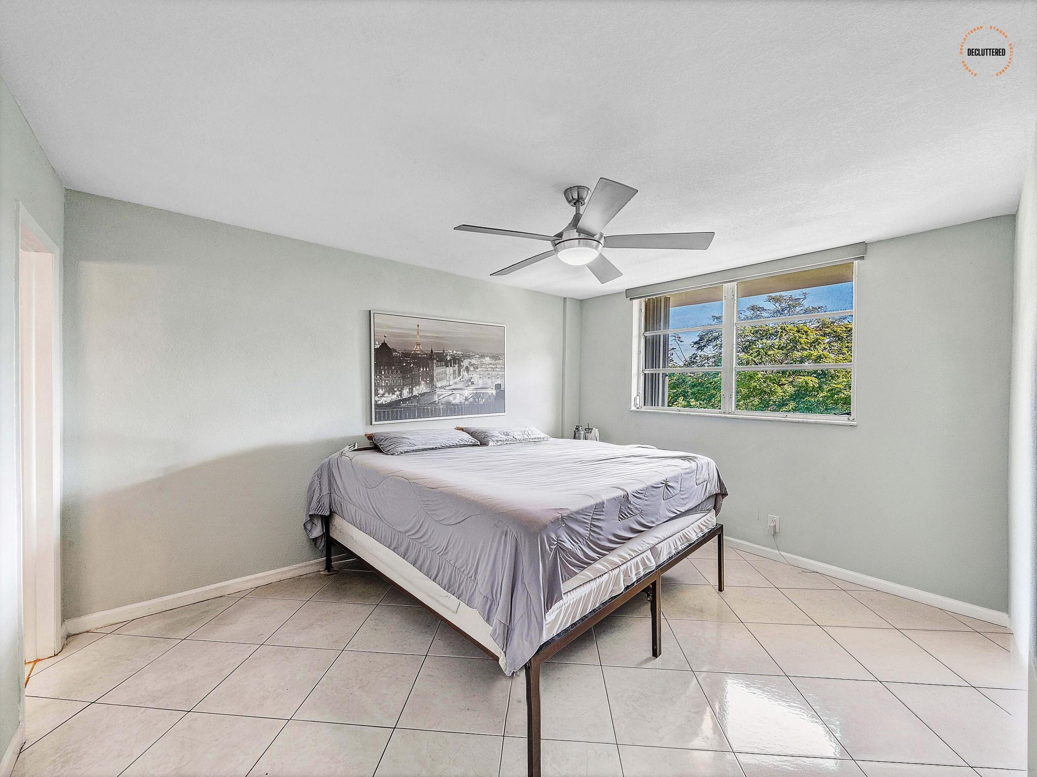 4500 North Federal Highway, Unit 303 Lighthouse Point, FL 33064 - Photo 24 of 40 a bedroom with a bed and a window