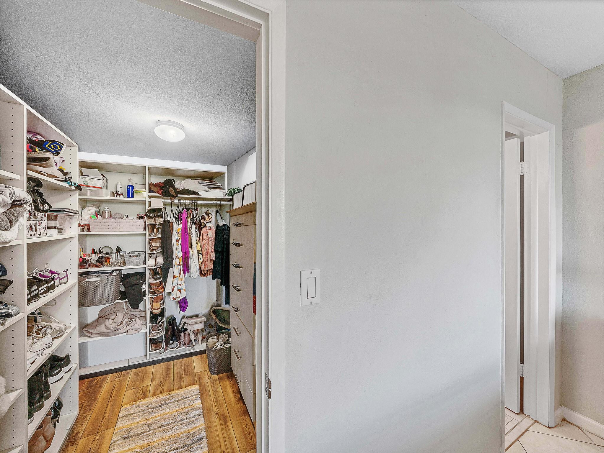 4500 North Federal Highway, Unit 303 Lighthouse Point, FL 33064 - Photo 27 of 40 a view of a walk in closet with clothes and shoes