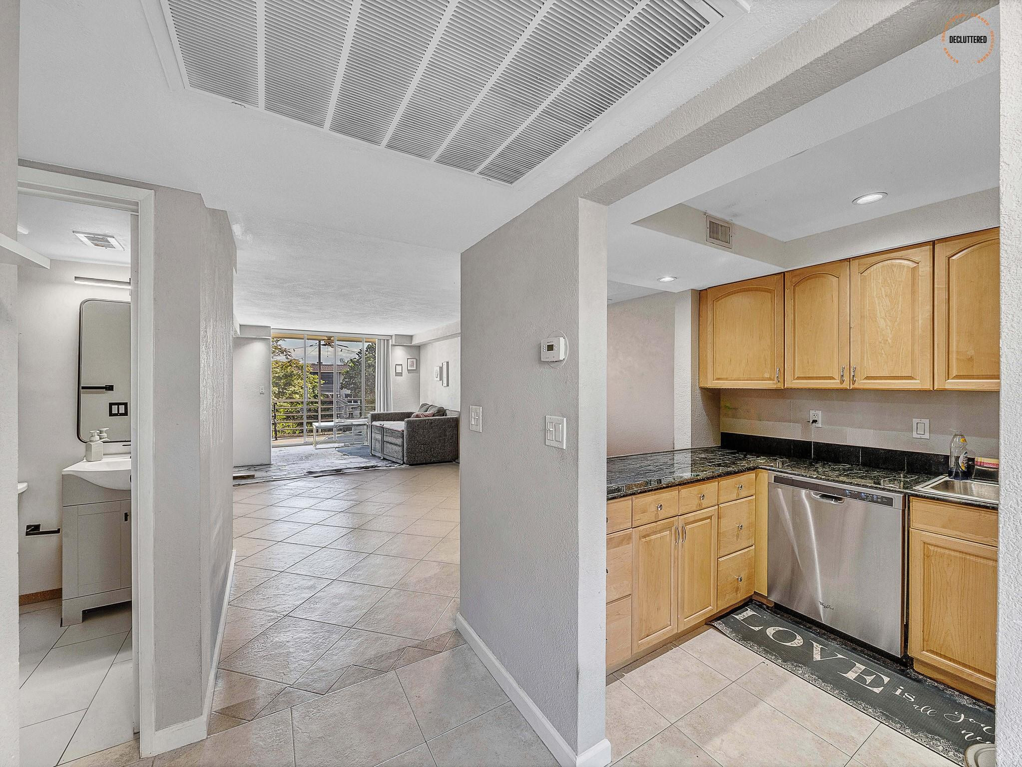 4500 North Federal Highway, Unit 303 Lighthouse Point, FL 33064 - Photo 8 of 40 a kitchen with granite countertop a sink and cabinets