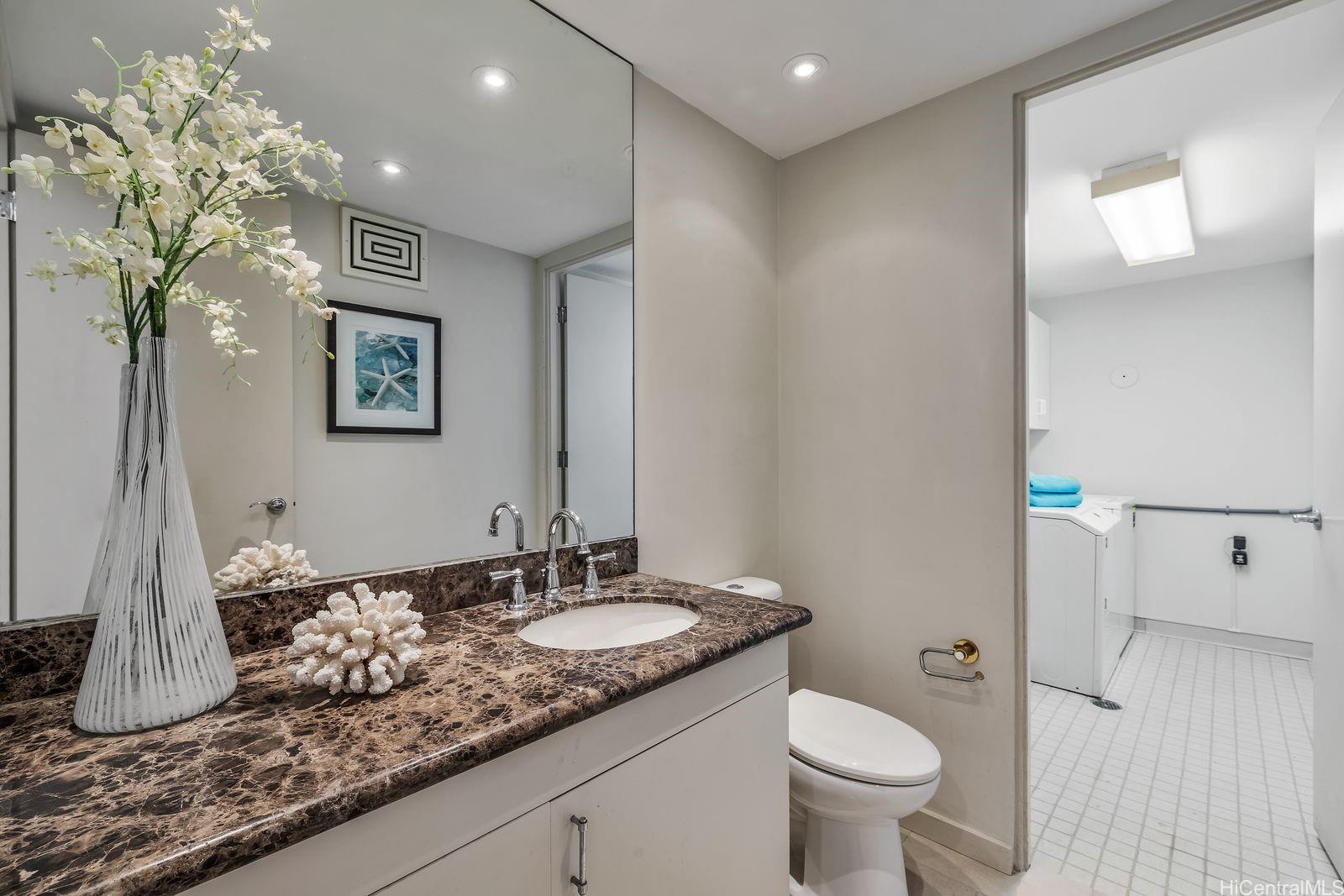 2929 Poni Moi Road, Unit 4 Honolulu, HI 96815 - Photo 19 of 25 a bathroom with a granite countertop sink a toilet and mirror