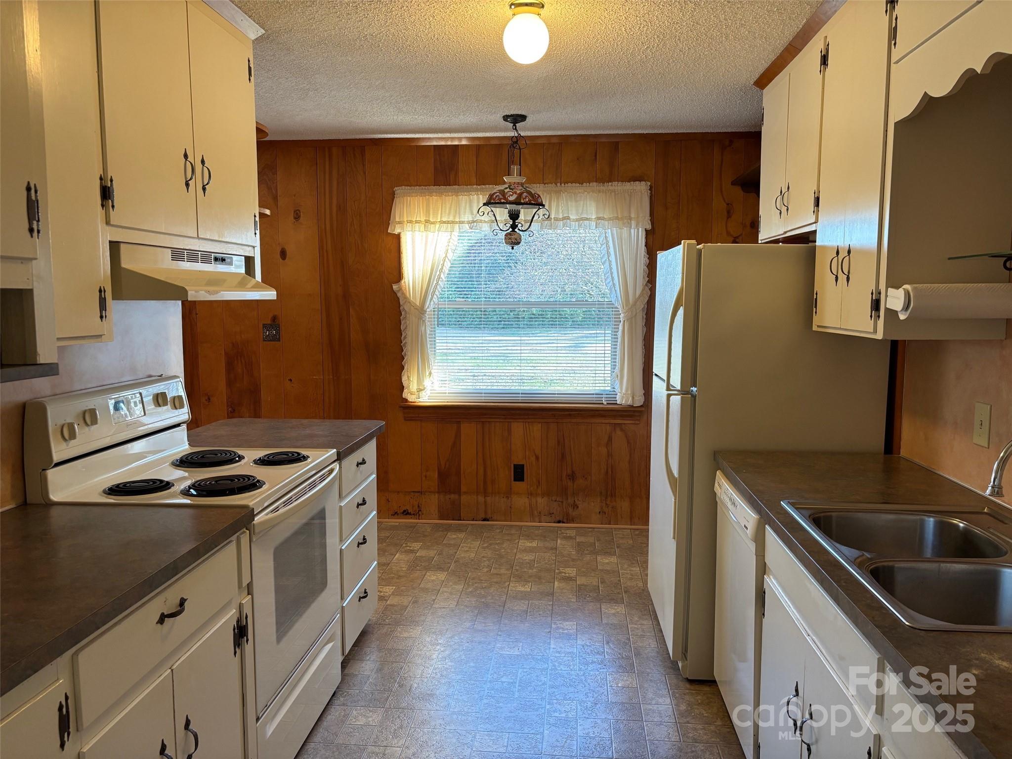 150 Old Georgia Road Statesville, NC 28625 - Photo 11 of 42 a kitchen with stainless steel appliances granite countertop a sink stove and refrigerator