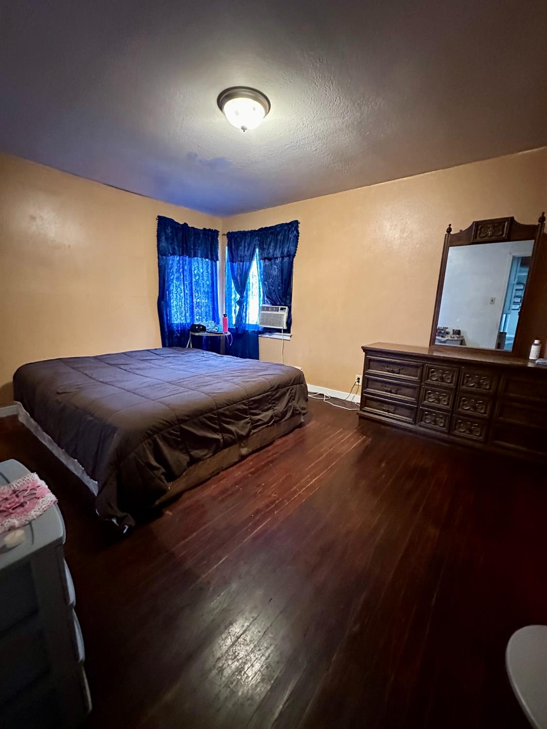 915 West Fountain Way Fresno, CA 93705 - Photo 12 of 20 a bedroom with a bed and wooden floor