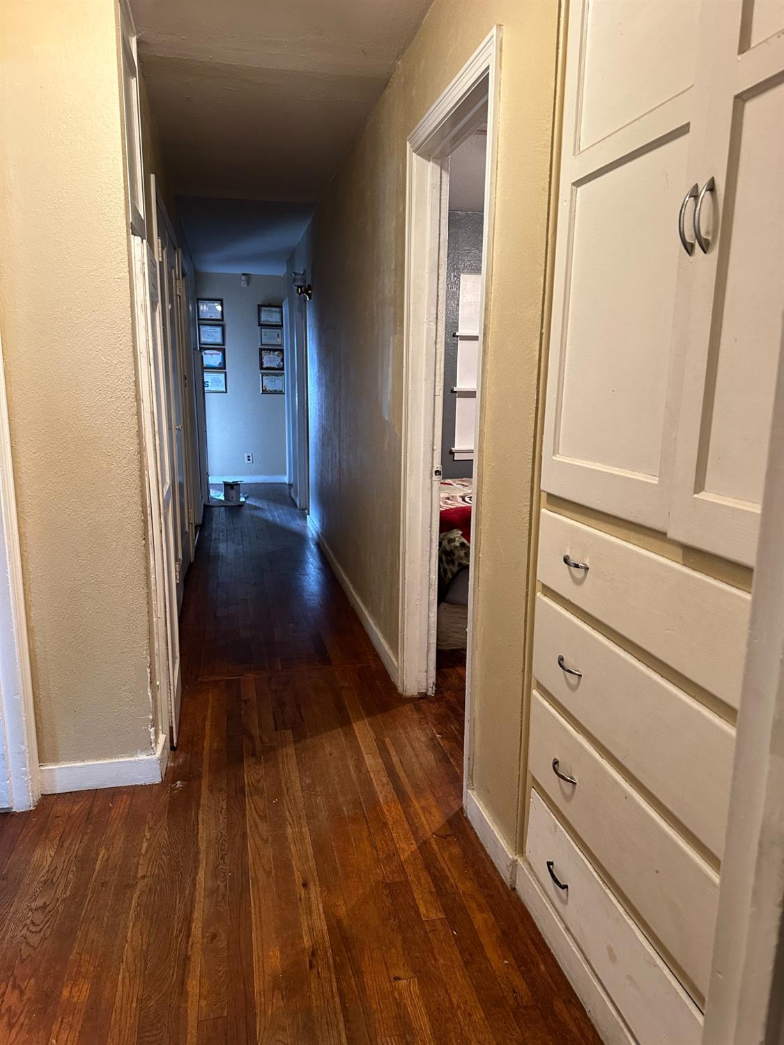 915 West Fountain Way Fresno, CA 93705 - Photo 14 of 20 a view of a hallway with wooden floor and stairs