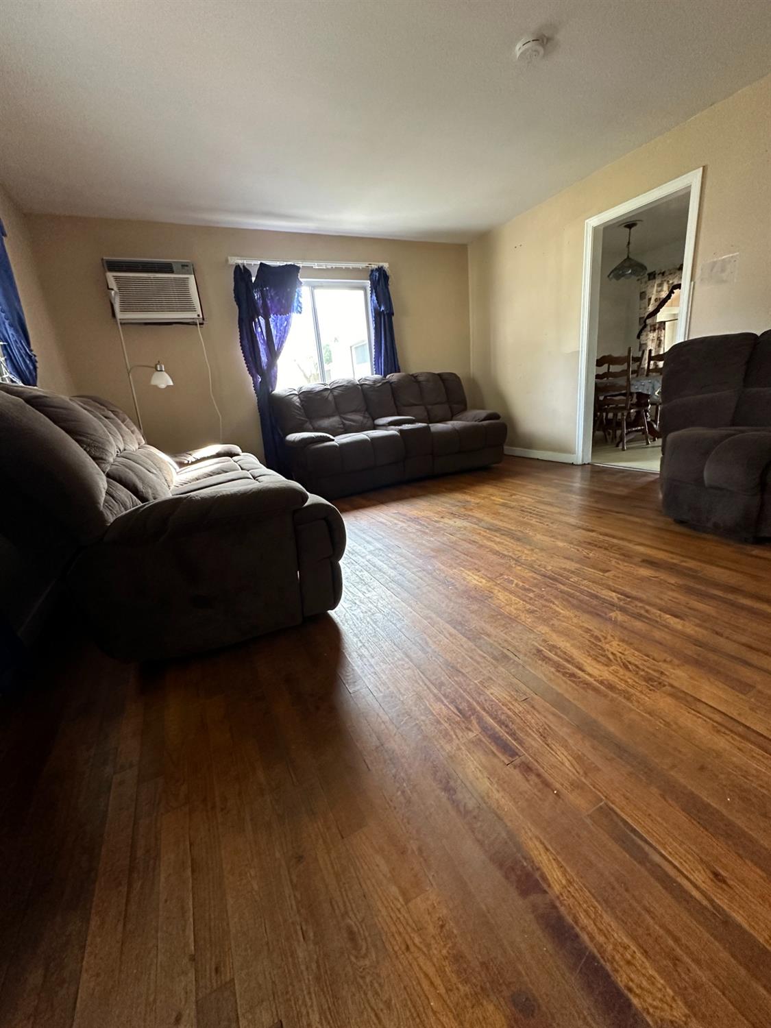 915 West Fountain Way Fresno, CA 93705 - Photo 4 of 20 a living room with furniture and a wooden floor