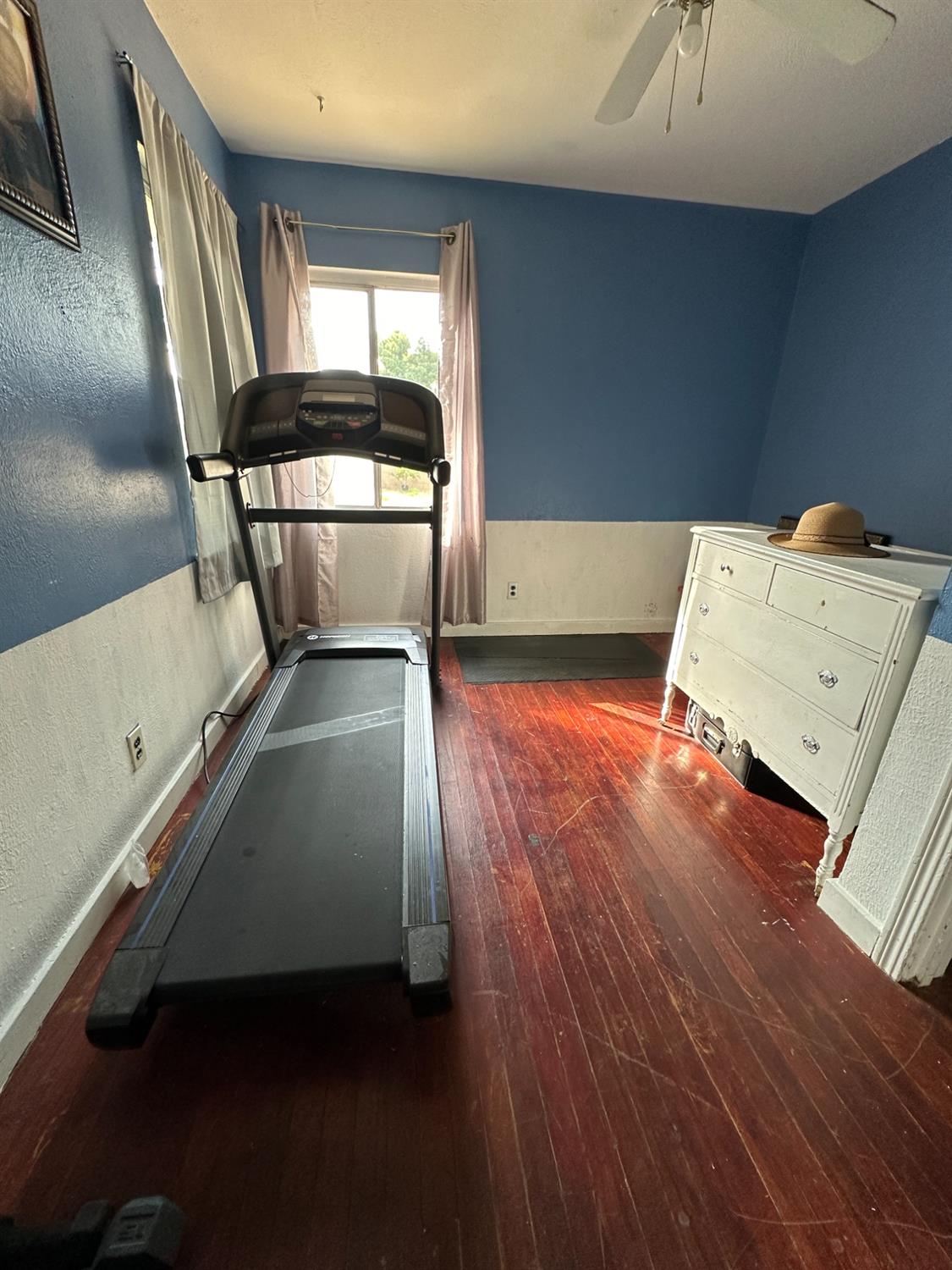 915 West Fountain Way Fresno, CA 93705 - Photo 10 of 20 an empty room with wooden floor and windows