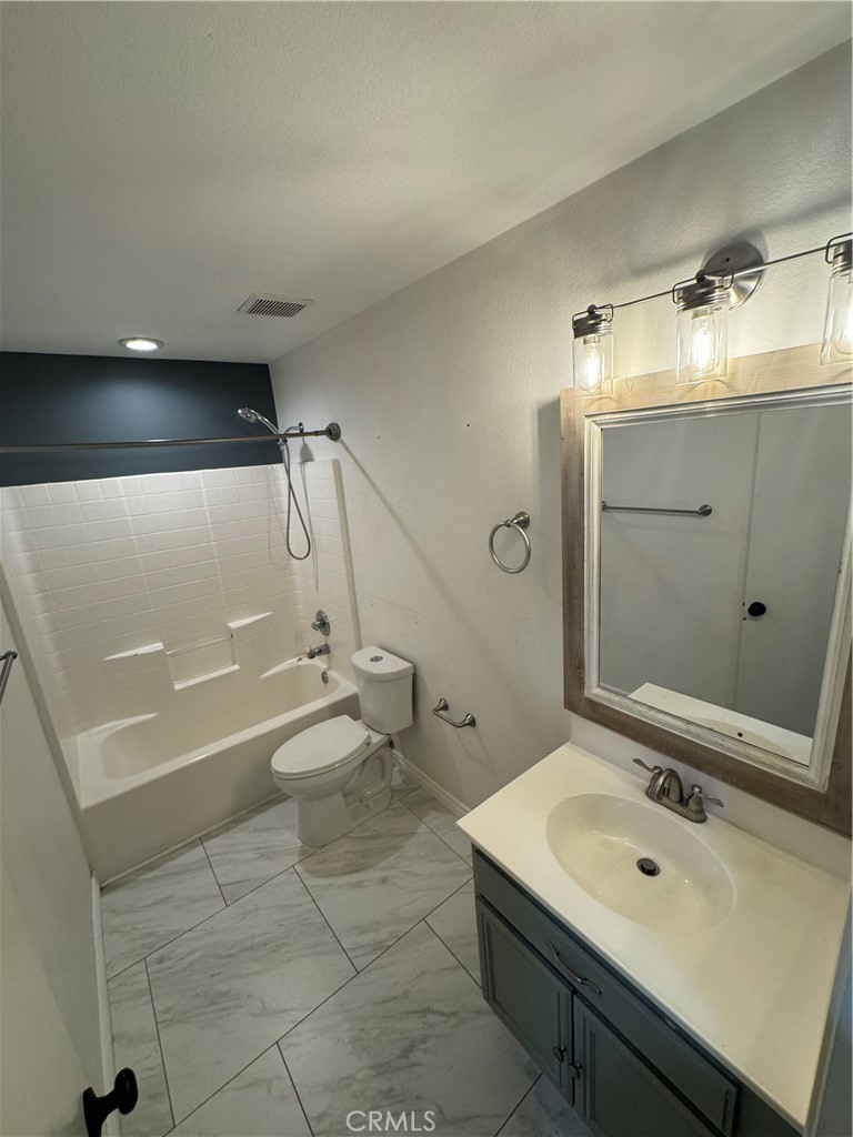 1517 Marigold Drive Perris, CA 92571 - Photo 19 of 47 a bathroom with a sink mirror and toilet