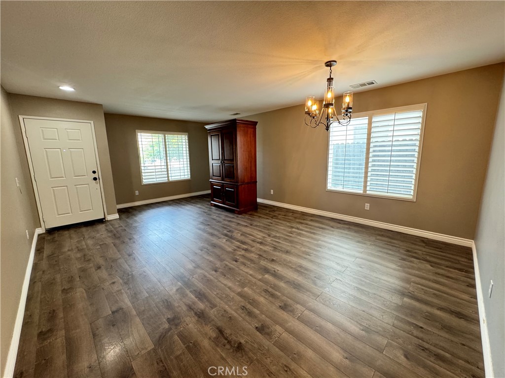 1517 Marigold Drive Perris, CA 92571 - Photo 32 of 47 a view of an empty room with a window and wooden floor