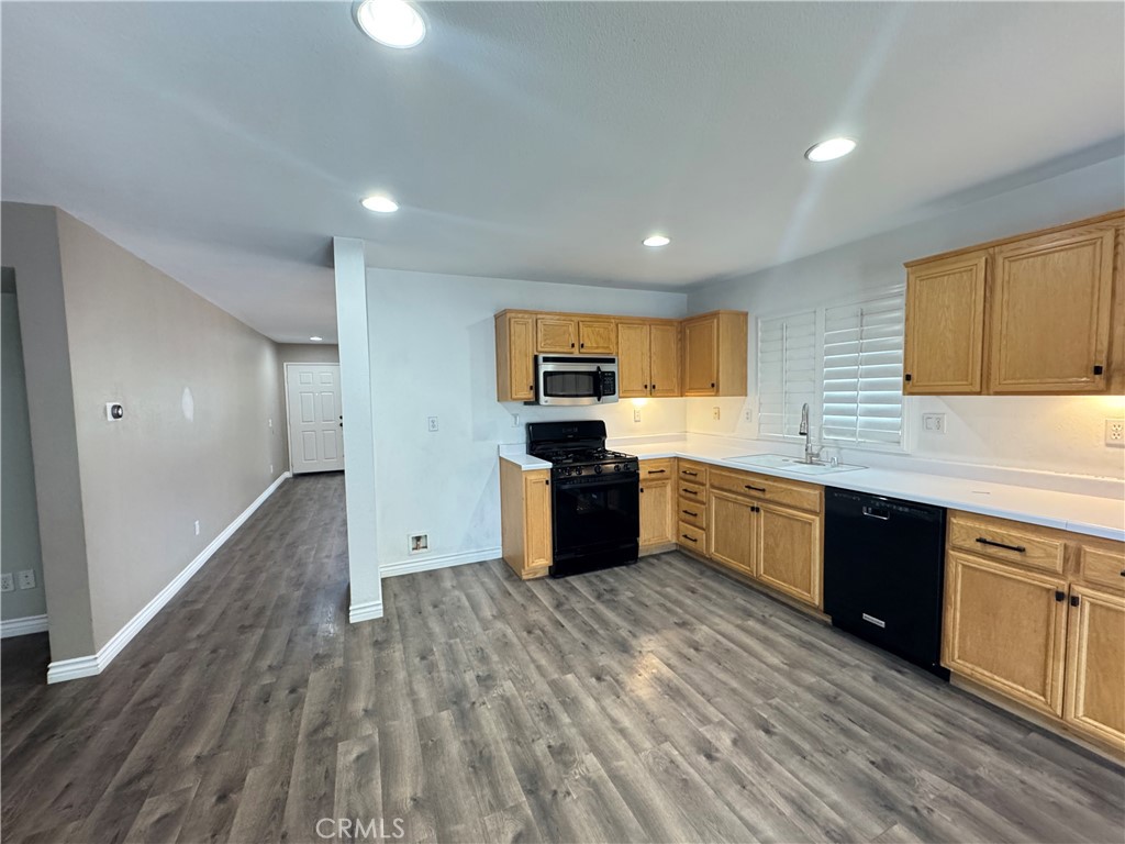 1517 Marigold Drive Perris, CA 92571 - Photo 38 of 47 a large kitchen with stainless steel appliances granite countertop a stove and a sink