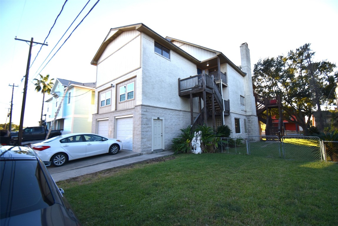 a car parked in front of a house and a yard