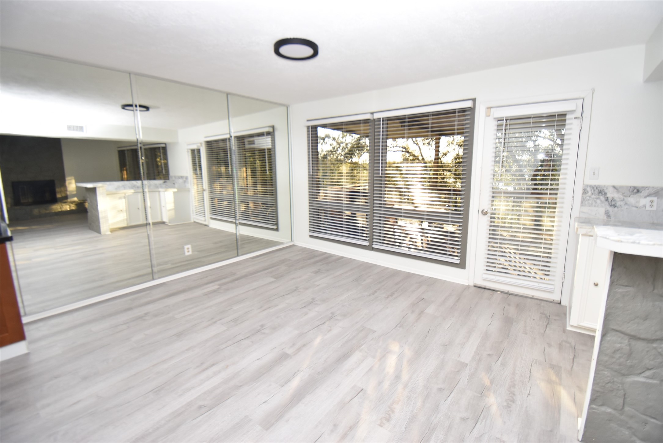 82 Harbor Lane Kemah, TX 77565 - Photo 6 of 33 a view of an empty room with wooden floor and a window