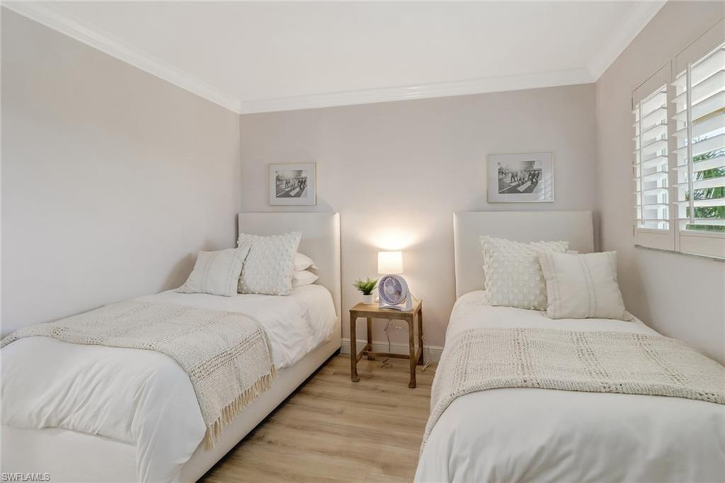 21 High Point Circle East, Unit 601 Naples, FL 34103 - Photo 15 of 22 a bedroom with a bed and a couch