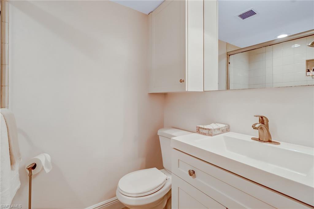 21 High Point Circle East, Unit 601 Naples, FL 34103 - Photo 16 of 22 a bathroom with a sink a toilet and vanity
