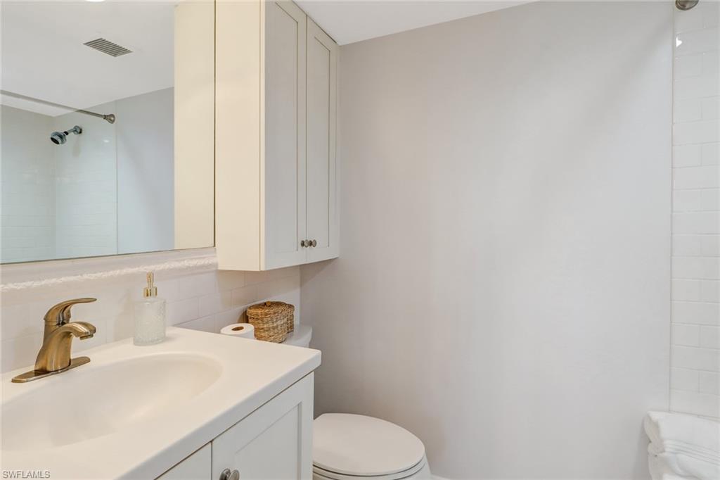 21 High Point Circle East, Unit 601 Naples, FL 34103 - Photo 19 of 22 a bathroom with a sink toilet and vanity
