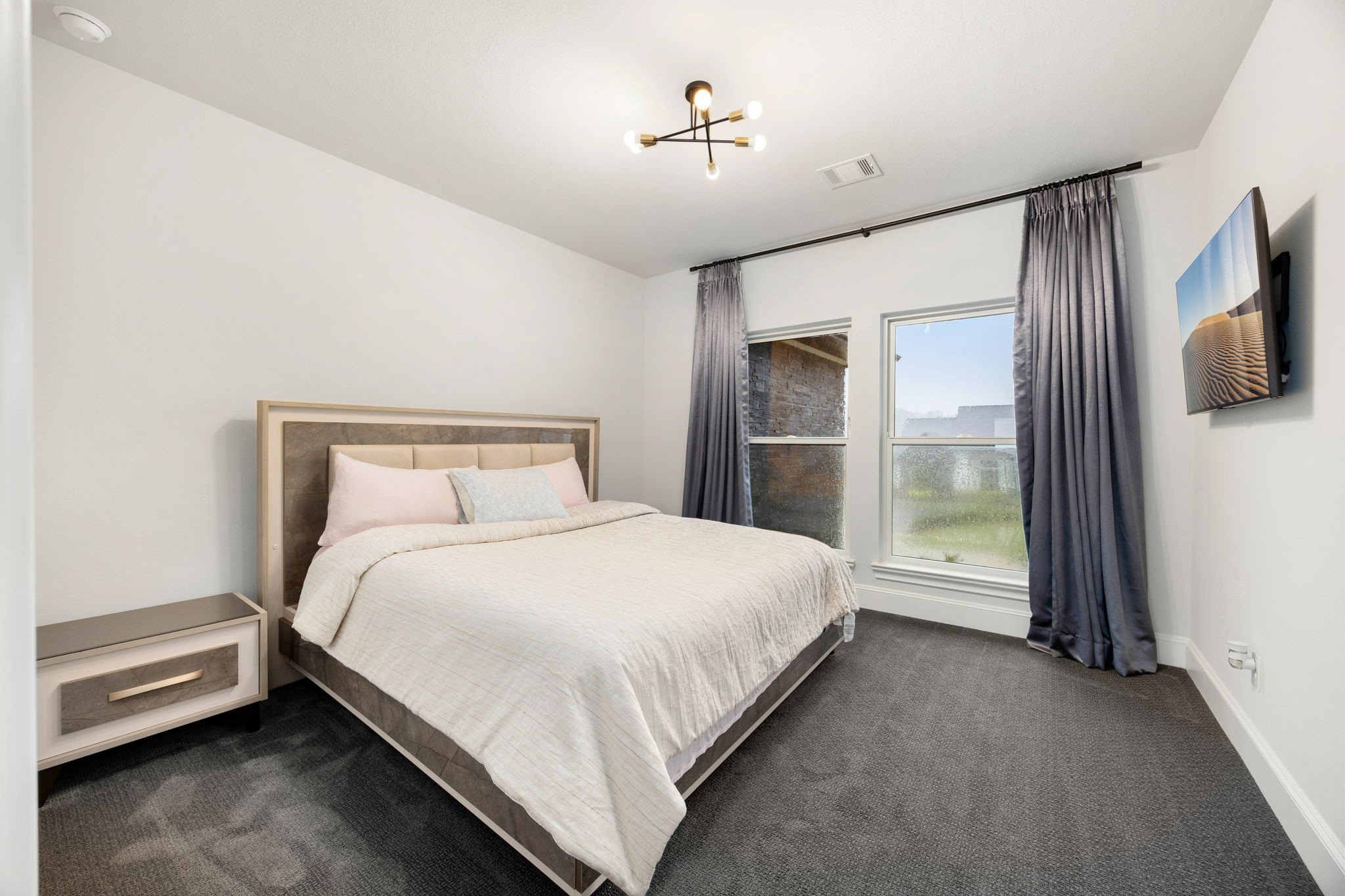 29419 Cir S Rnch Trail Fulshear, TX 77406 - Photo 28 of 45 This comfortable secondary bedroom layout offers a neutral palette with light gray walls, a contemporary light fixture and continuous dark carpet flooring.
