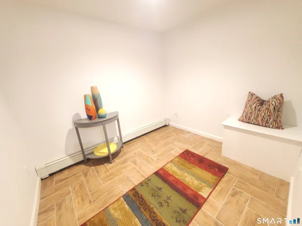 a bedroom with a bed and a potted plant