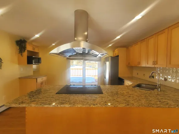 a view of a kitchen with a sink and window