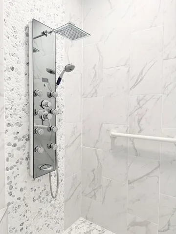 an empty room with chandelier fan and windows