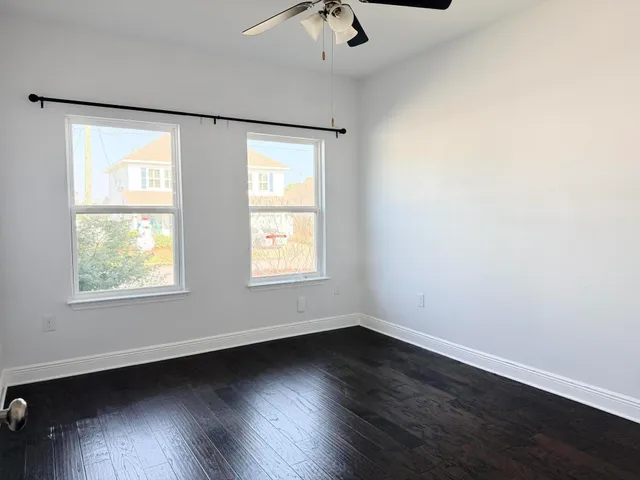 wooden floor in an empty room with a window