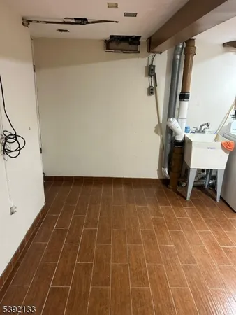 a view of a room with wooden floor and white walls