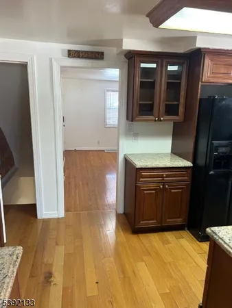 a kitchen with granite countertop a stove and a refrigerator