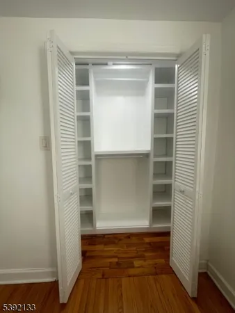 a empty closet with wooden floor