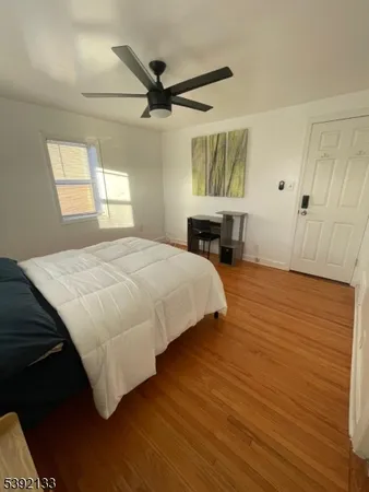 a bedroom with a bed dresser and a window