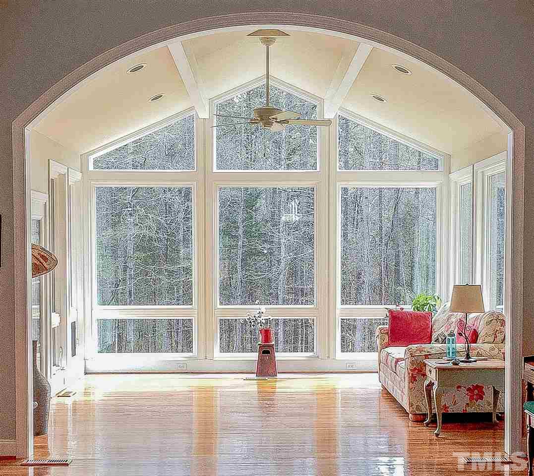 114 Bynum Ridge Road Pittsboro, NC 27312 - Photo 3 of 23 The focal point of the house, this magnificent sun room features a 15-foot vaulted ceiling and breathtaking views of nature. The sun room was added in 2016 and creates an indelible impression as you enter the front door.