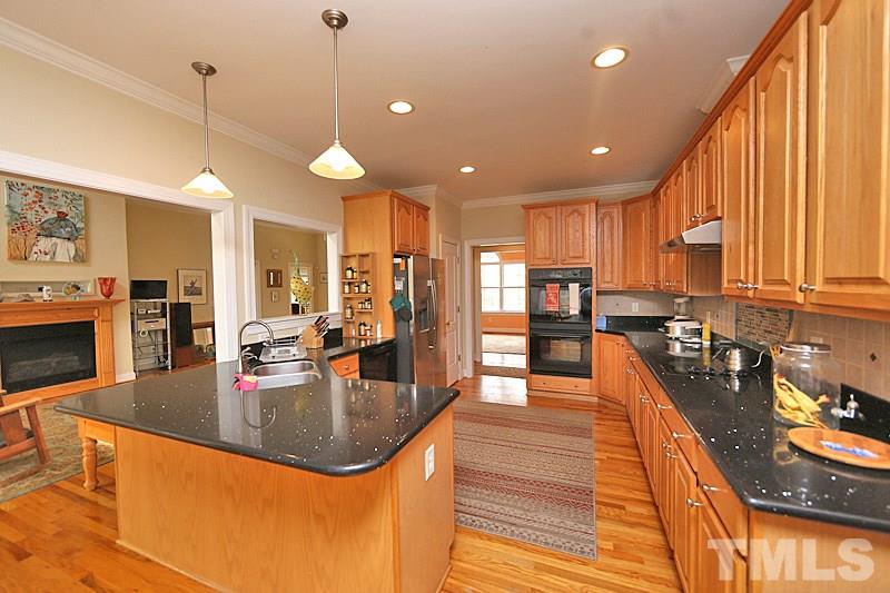 114 Bynum Ridge Road Pittsboro, NC 27312 - Photo 5 of 23 The kitchen also opens to the family room and features black quartz counters, a double oven and plenty of room to plot your next gourmet meal.
