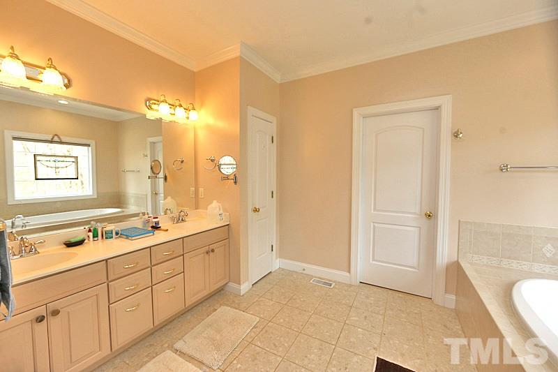 114 Bynum Ridge Road Pittsboro, NC 27312 - Photo 8 of 23 There is plenty of elbow room in the master bath with dual vanities and "his and her" closets.