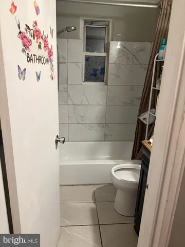 a bathroom with a shower and toilet