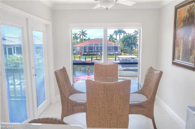 a view of a dining room with furniture and a large window