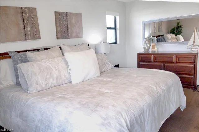 a spacious bathroom with a double vanity sink toilet mirror and shower