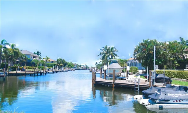 a view of a lake with boats and trees in the background