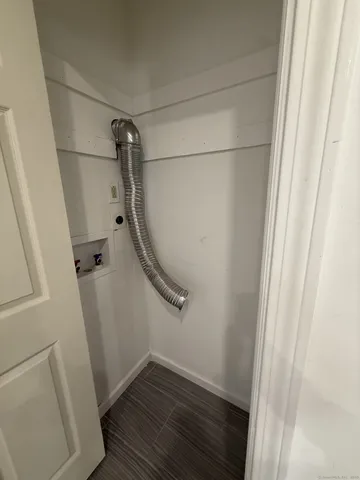 a view of a room with wooden floor and white walls