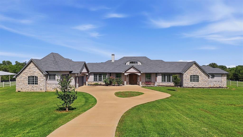 326 Turkey Farm Road Whitesboro, TX 76273 - Photo 1 of 1 Expansive property featuring a stone and stucco exterior, multiple gables, a circular drive, and a manicured lawn