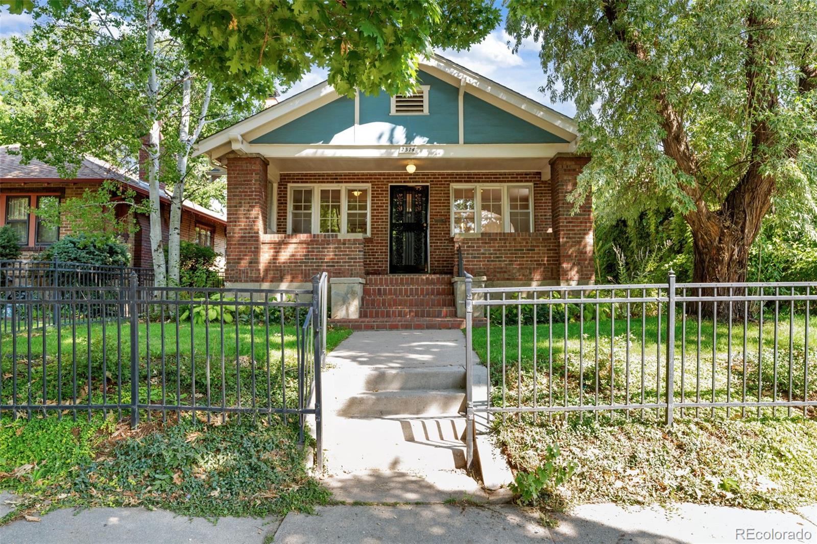 a front view of a house with a yard table and chairs
