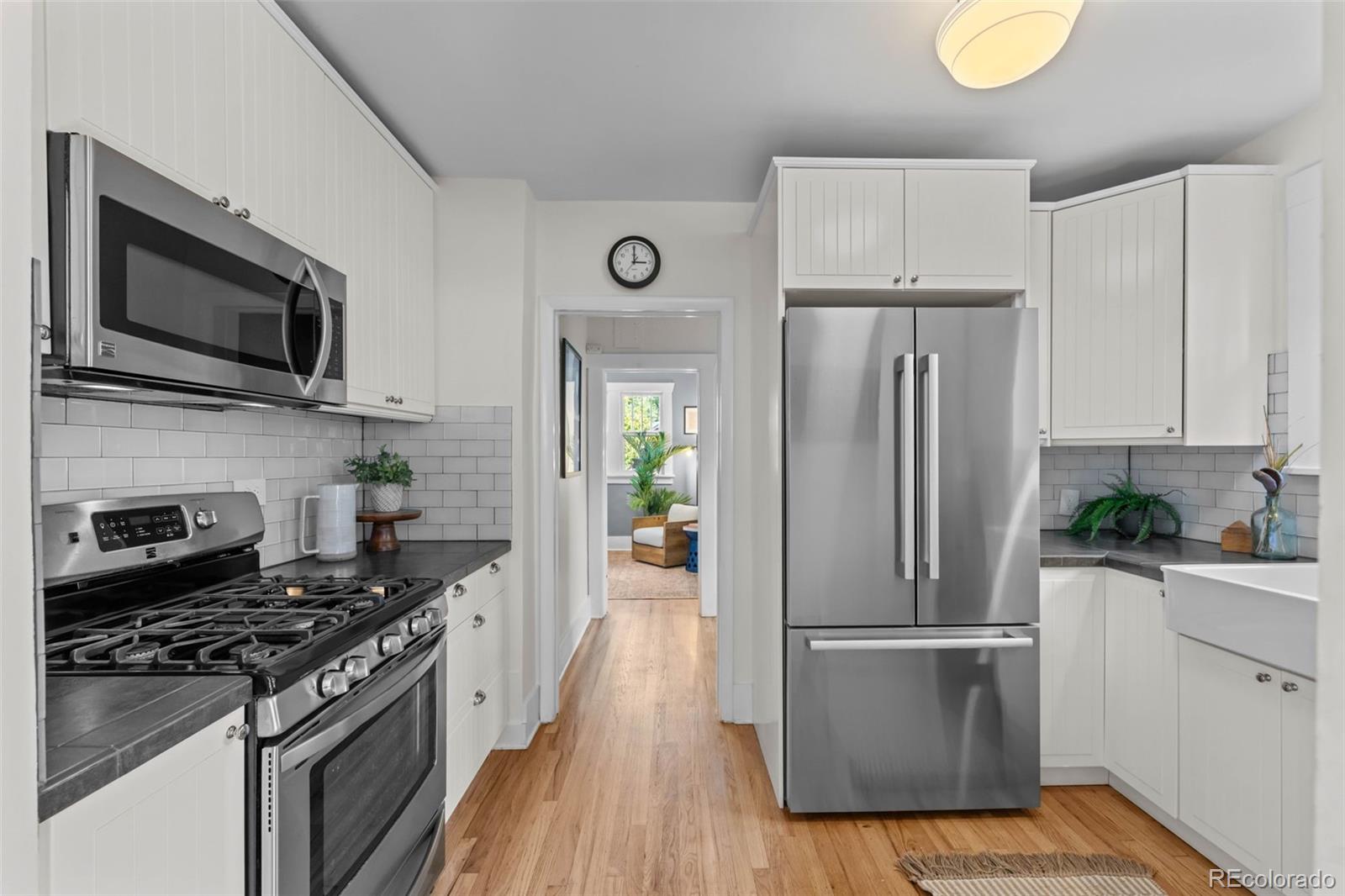 2314 Grape Street Denver, CO 80207 - Photo 16 of 49 a kitchen with a refrigerator and a stove top oven