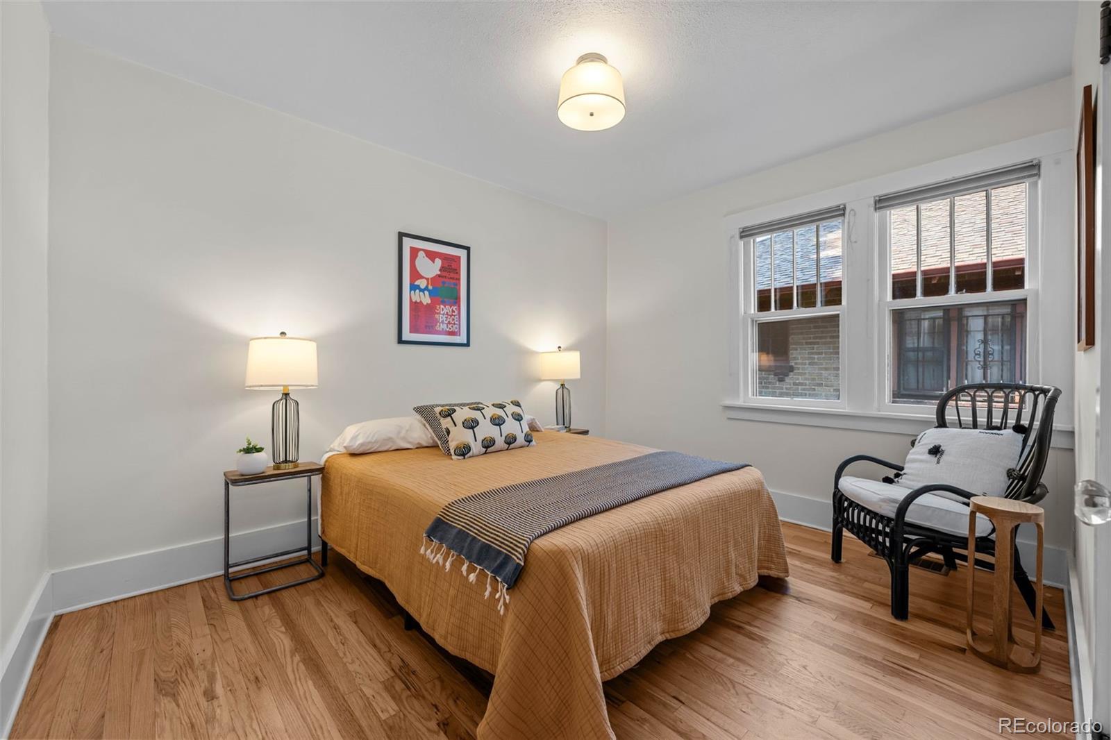 2314 Grape Street Denver, CO 80207 - Photo 21 of 49 a bedroom with a bed and wooden floor