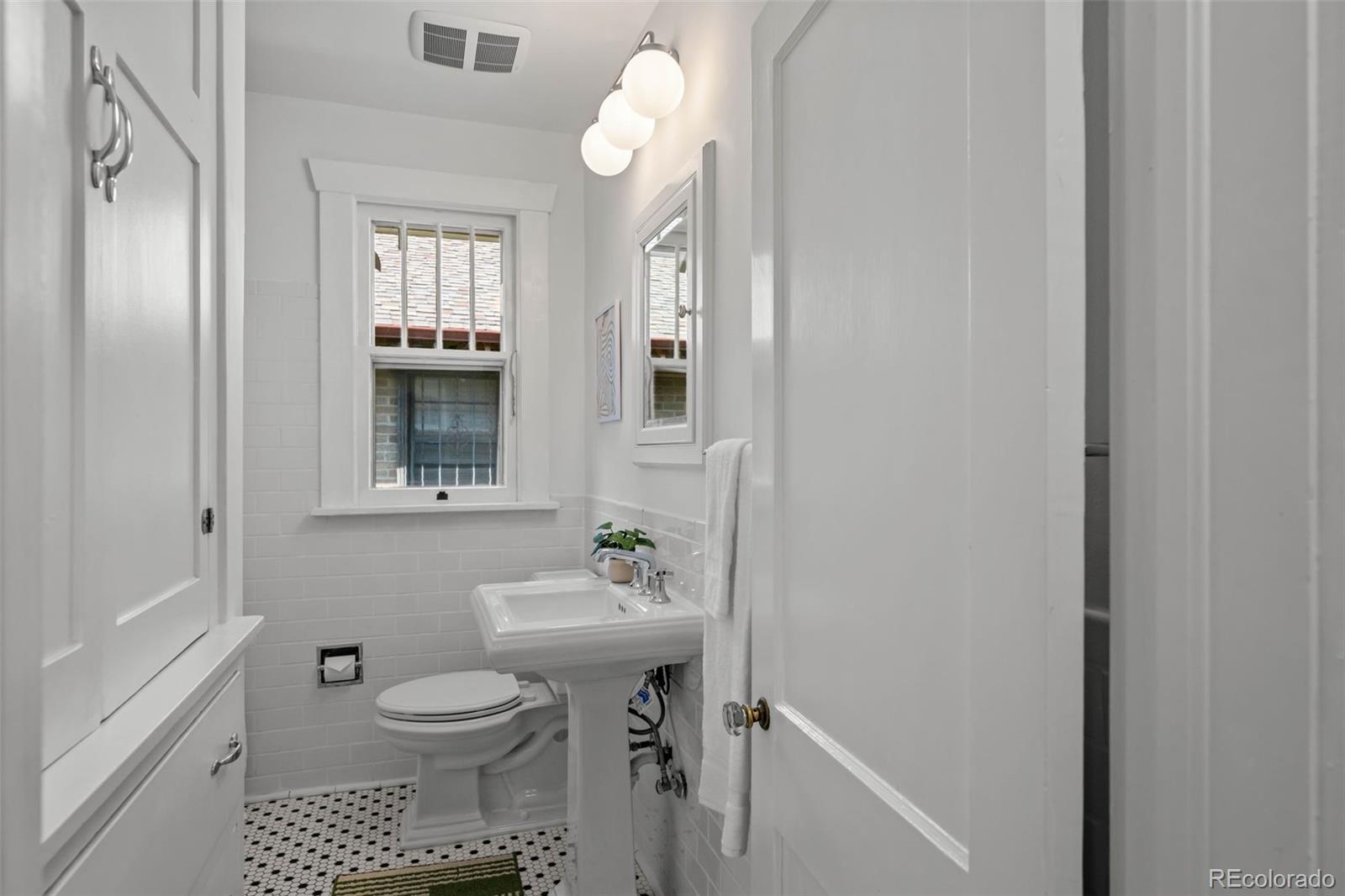 2314 Grape Street Denver, CO 80207 - Photo 23 of 49 a bathroom with a sink a toilet and shower