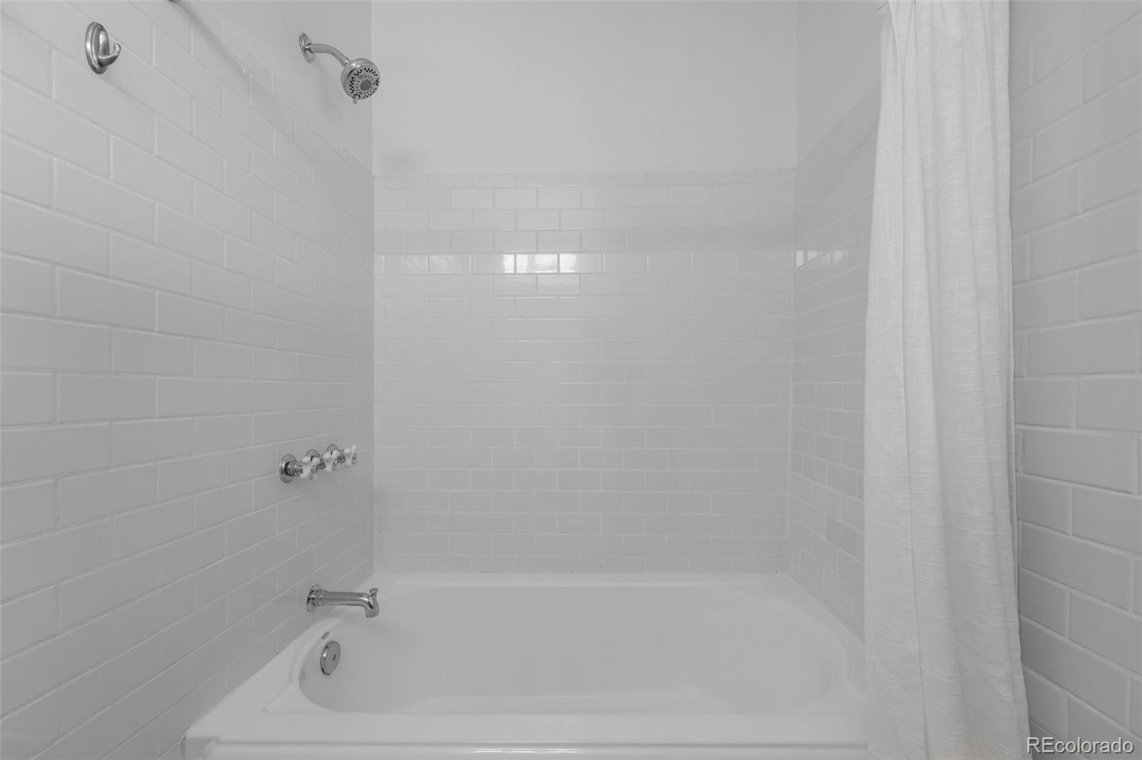 2314 Grape Street Denver, CO 80207 - Photo 24 of 49 a close up of a bathtub curtain