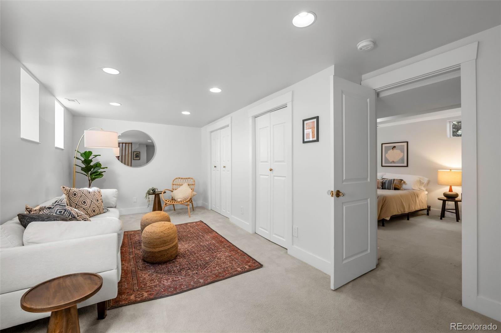 2314 Grape Street Denver, CO 80207 - Photo 27 of 49 a living room with furniture and a chandelier