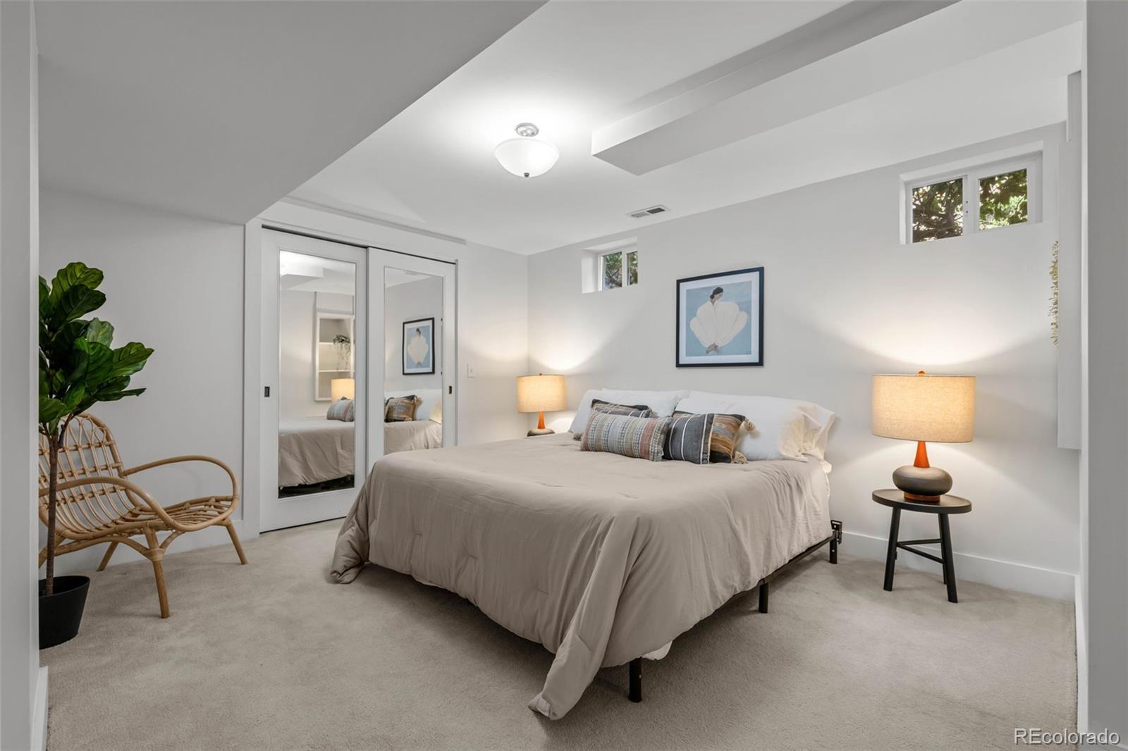 2314 Grape Street Denver, CO 80207 - Photo 29 of 49 a bedroom with a bed and lamp