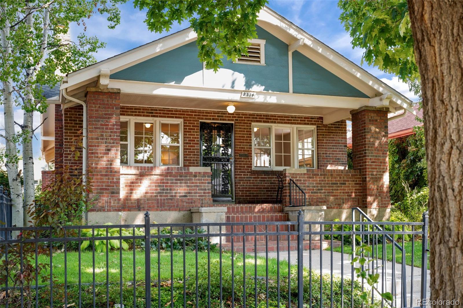 2314 Grape Street Denver, CO 80207 - Photo 3 of 49 a front view of a house with a garden
