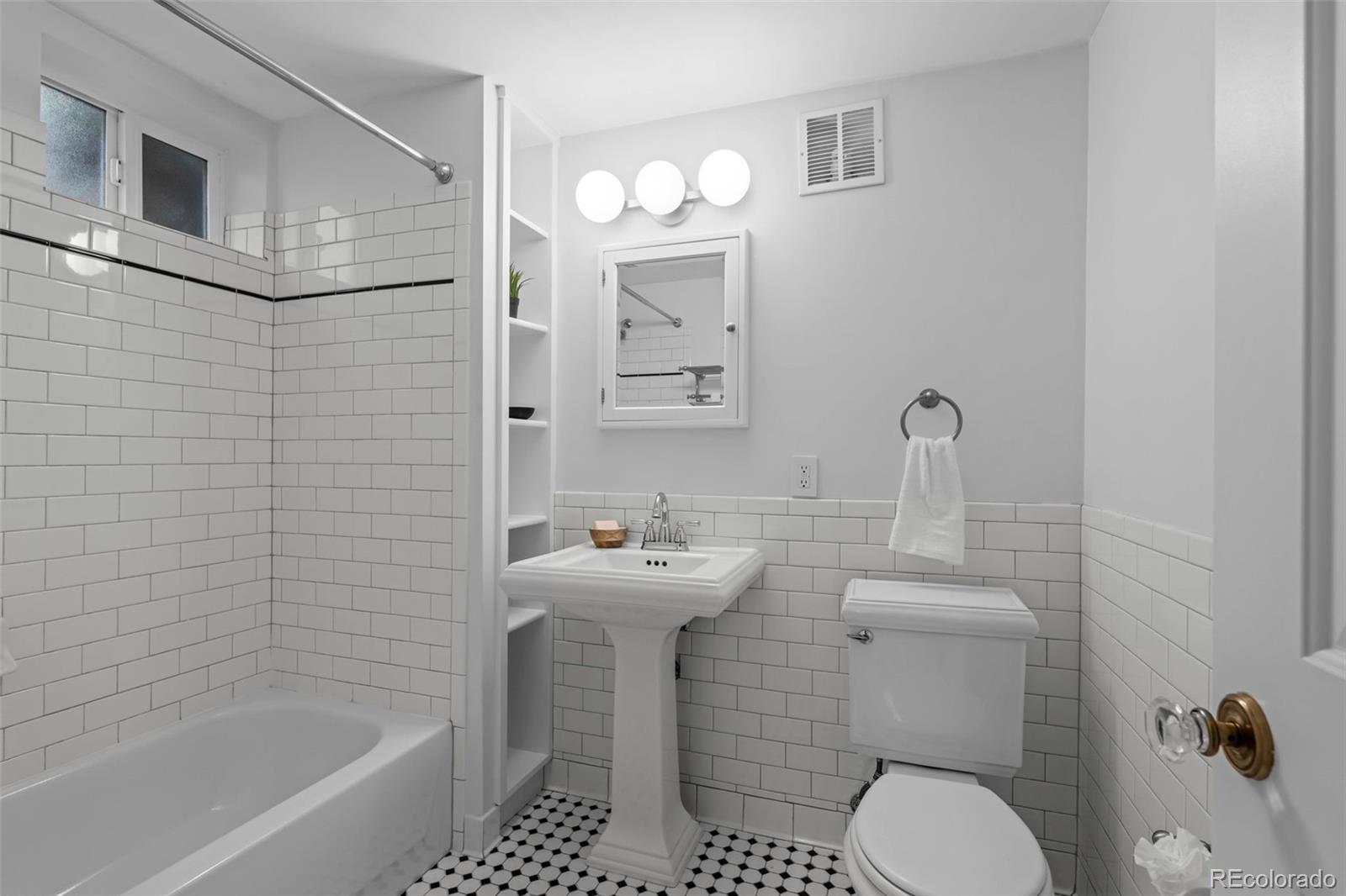 2314 Grape Street Denver, CO 80207 - Photo 31 of 49 a bathroom with a sink a toilet and shower