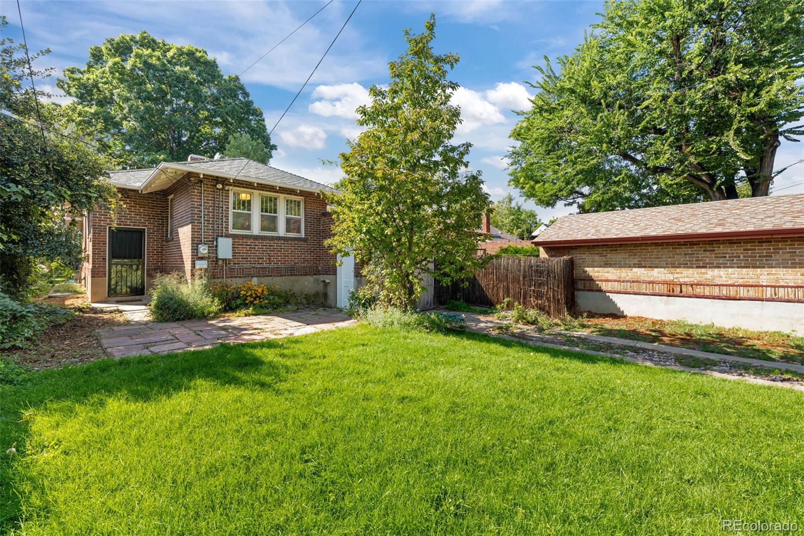 2314 Grape Street Denver, CO 80207 - Photo 34 of 49 a front view of a house with a yard and garage