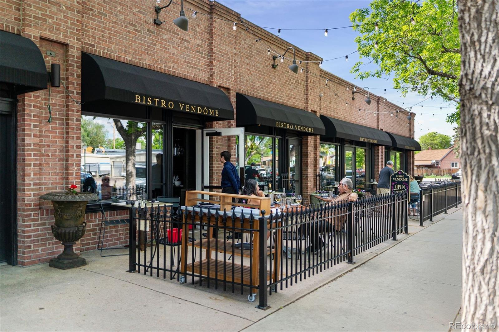 2314 Grape Street Denver, CO 80207 - Photo 39 of 49 a view of a patio with a table and chairs and potted plants