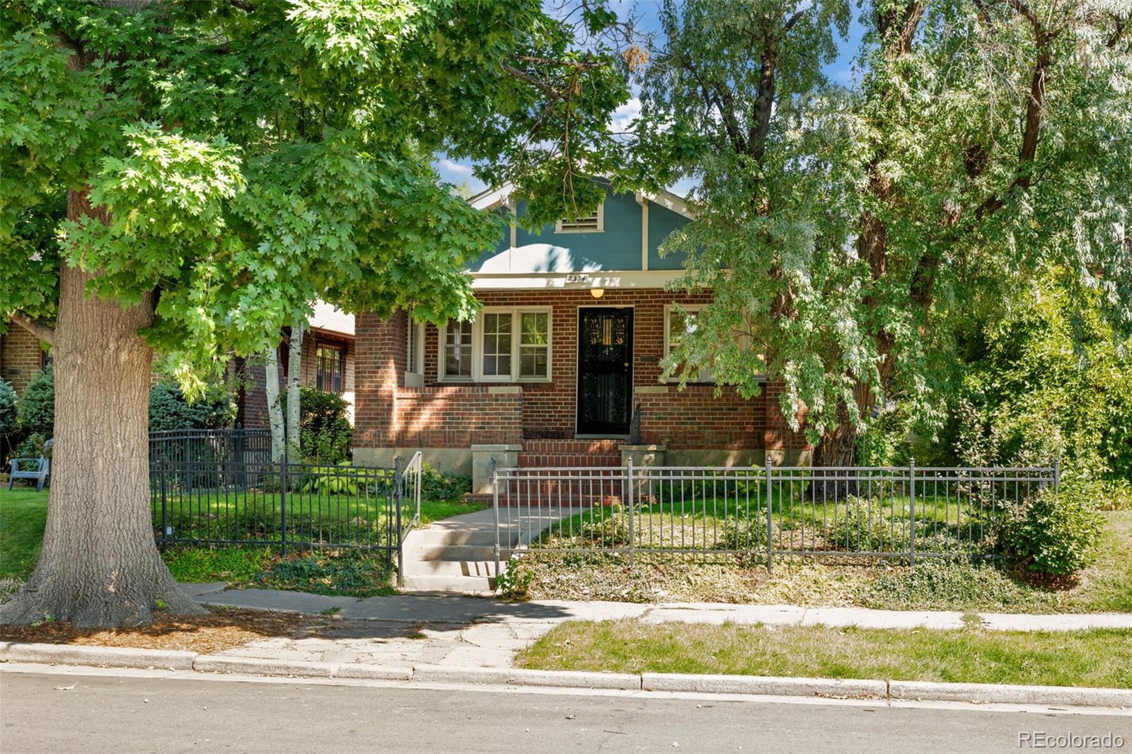 2314 Grape Street Denver, CO 80207 - Photo 4 of 49 a front view of a house with a garden