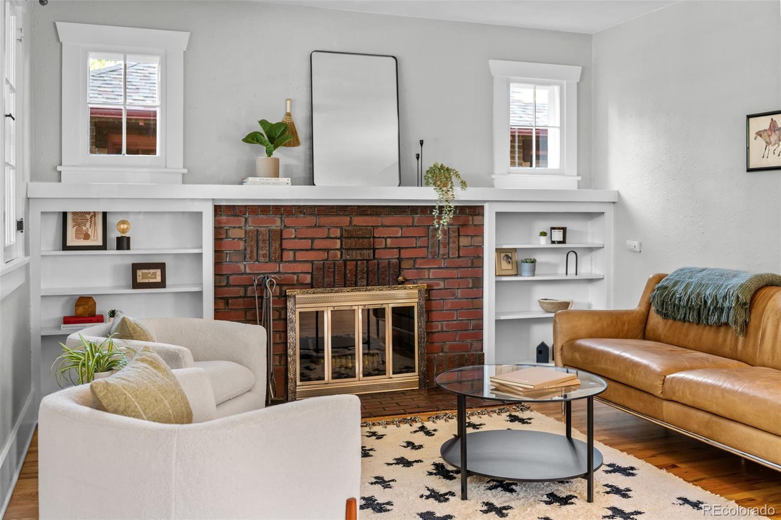 2314 Grape Street Denver, CO 80207 - Photo 6 of 49 a living room with furniture a fireplace and a window